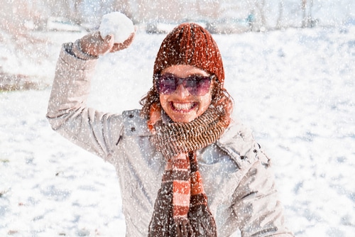 Woman in the show throwing a snowball
