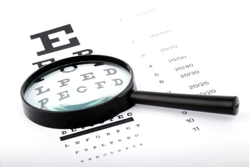 magnifying glass on an eye chart
